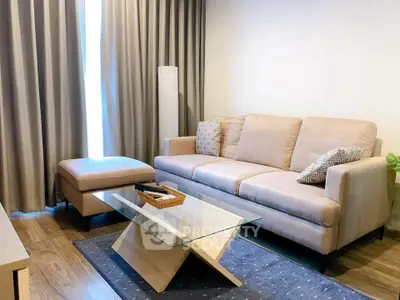 Stylish living room with modern beige sofa and glass coffee table