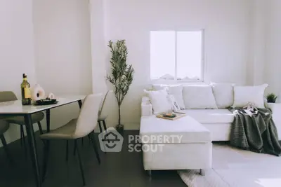 Modern living room with cozy white sofa and dining area