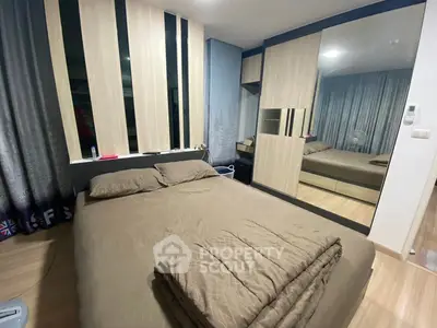 Modern bedroom with stylish decor and mirrored wardrobe in cozy apartment.