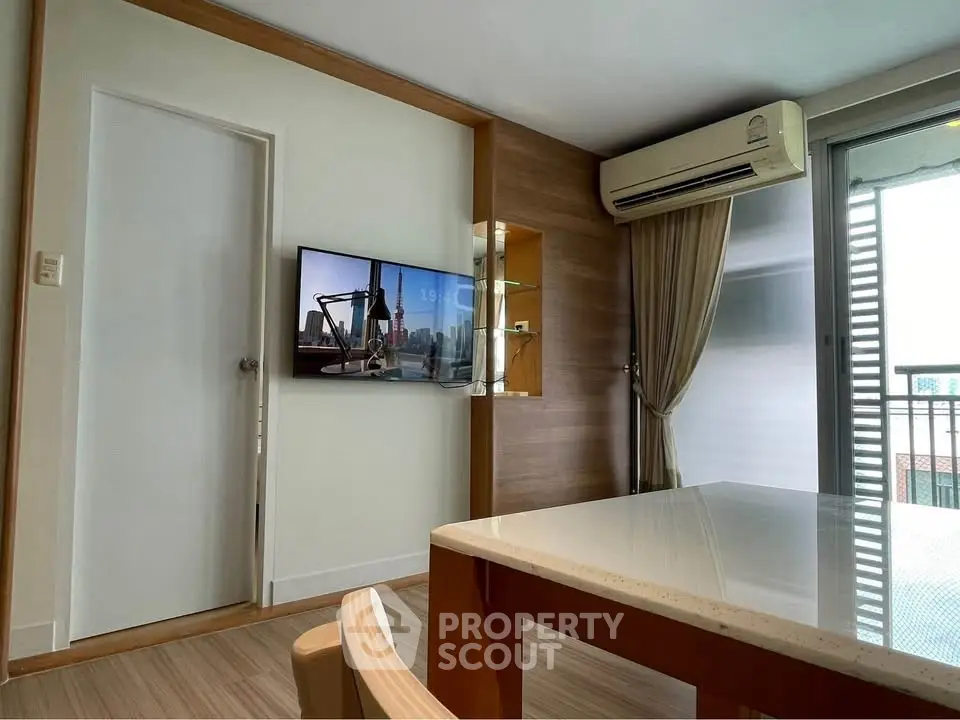 Modern living room with air conditioning and balcony access in a stylish apartment.