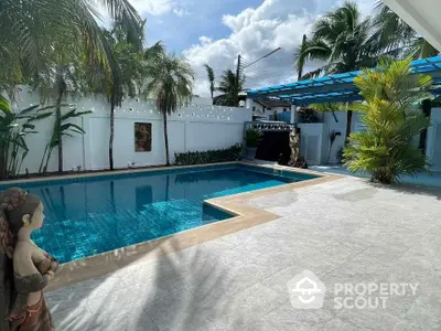 Luxurious private pool area with tropical landscaping and modern design