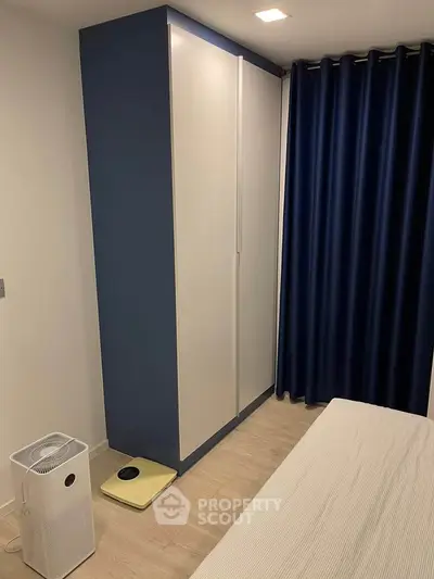 Modern bedroom with sleek wardrobe and air purifier