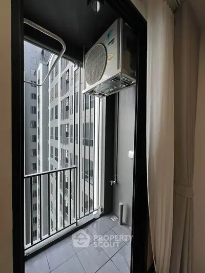 Modern apartment balcony with city view and air conditioning unit