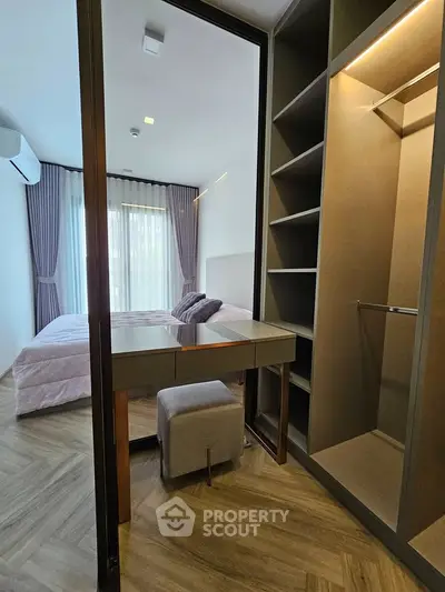 Modern bedroom with walk-in closet and elegant decor in a stylish apartment.