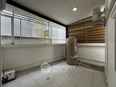 Spacious tiled balcony with modern design and ample natural light, perfect for relaxation or storage.