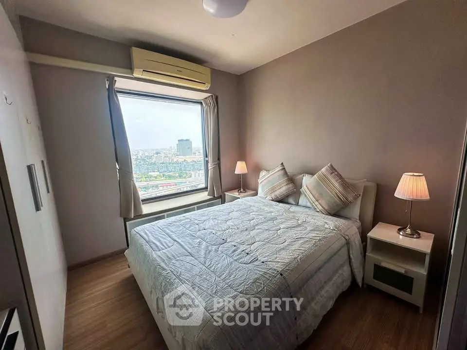 Cozy bedroom with city view, featuring a comfortable bed and stylish decor, perfect for relaxation.
