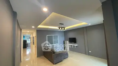 Modern living room with stylish ceiling lights and cozy gray sofa