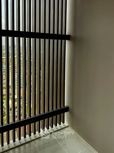 Modern balcony with city view and sleek vertical slats for privacy.