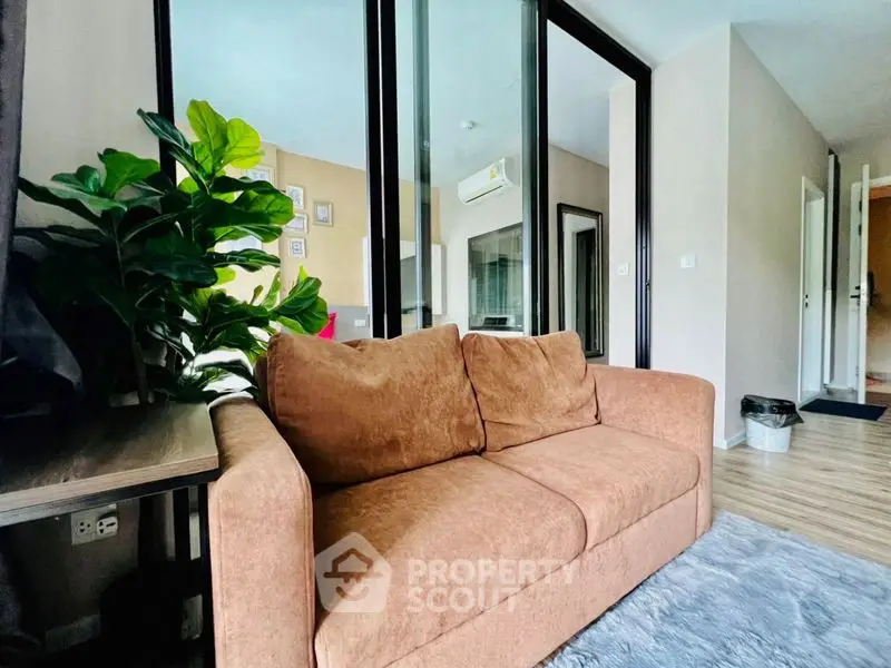 Modern living room with cozy brown sofa and stylish decor in a contemporary apartment.