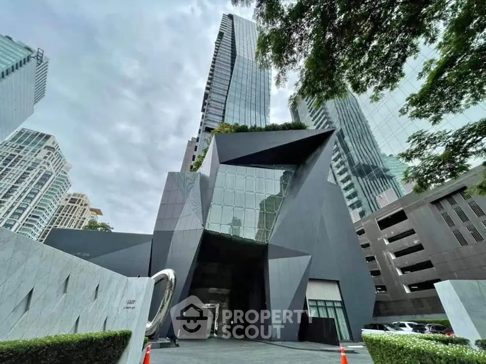 Stunning modern architectural building with sleek design and lush greenery in urban setting.