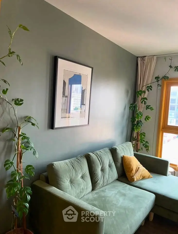 Charming living room with green sofa and plants, perfect for relaxation and modern living.