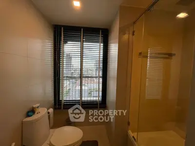 Modern bathroom with city view and glass shower enclosure