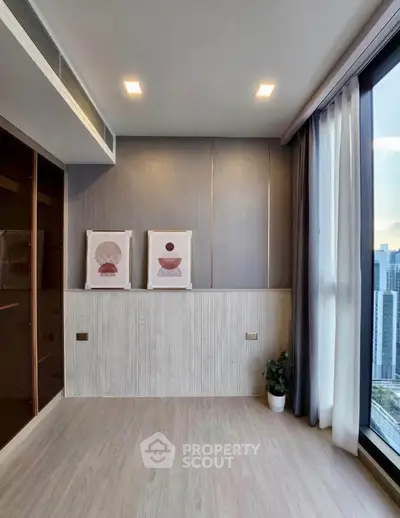 Modern minimalist room with large windows and city view, perfect for a stylish living space.