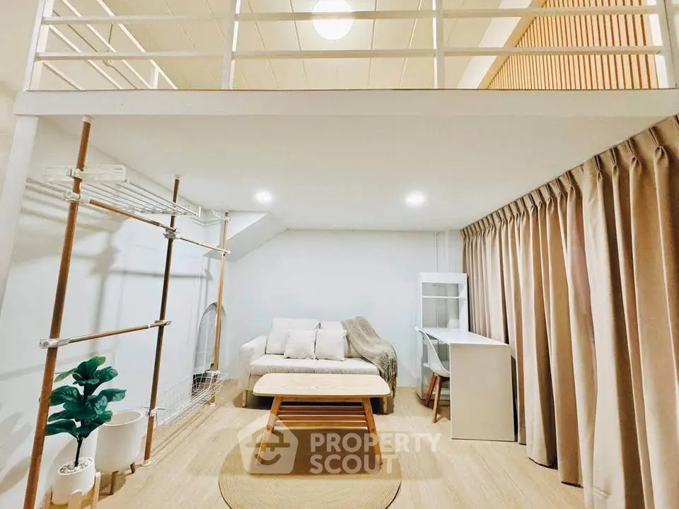 Modern loft-style living room with cozy seating and natural light