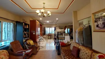 Spacious living room with elegant chandelier and cozy seating area