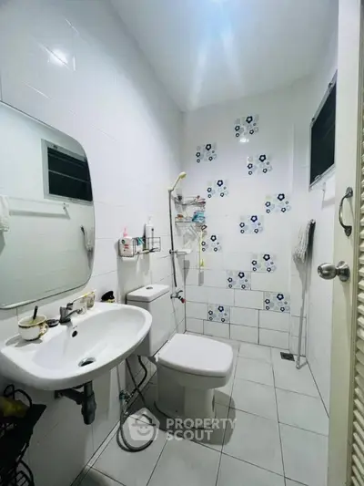 Compact bathroom with modern fixtures and decorative tile accents