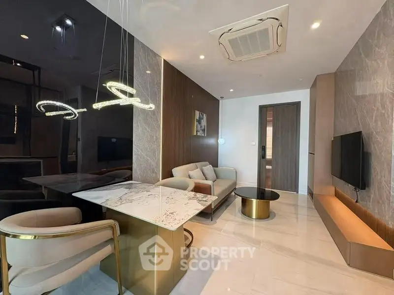 Luxurious modern living room with elegant marble dining table and stylish lighting fixtures.