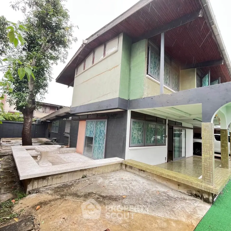 Spacious two-story home with unique architectural design and ample outdoor space.