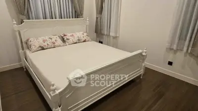 Charming bedroom with elegant white bed and cozy decor, perfect for restful nights.