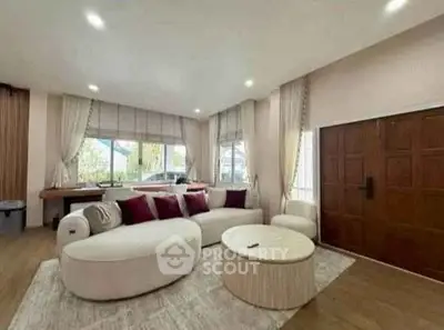 Spacious living room with modern furniture and large windows for natural light.