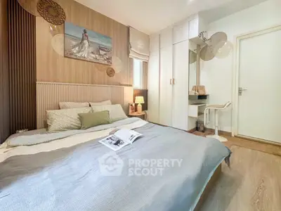 Cozy bedroom with modern decor and ample storage space, featuring a stylish bed and elegant wall art.