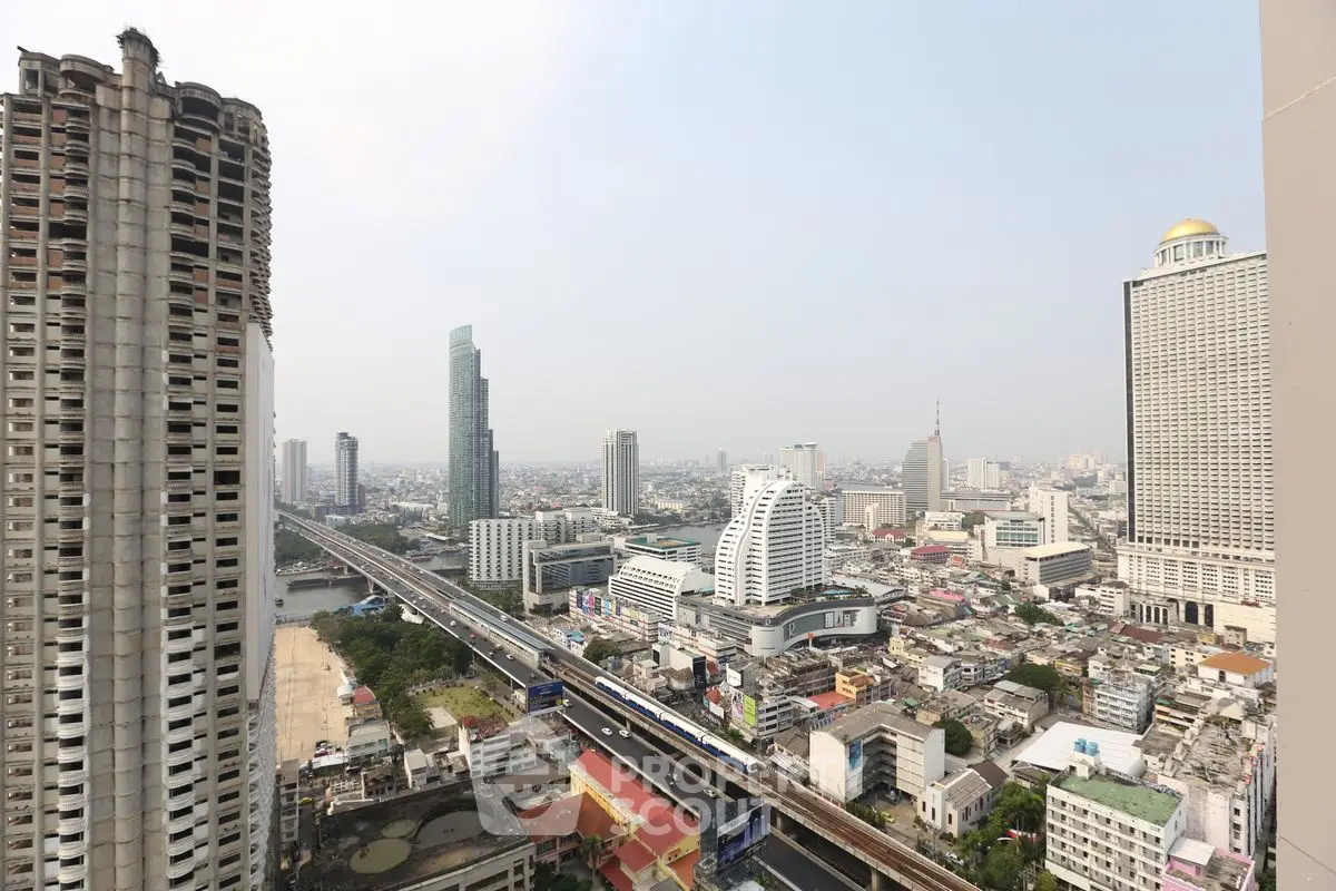 Stunning cityscape view from high-rise building overlooking urban skyline and river.