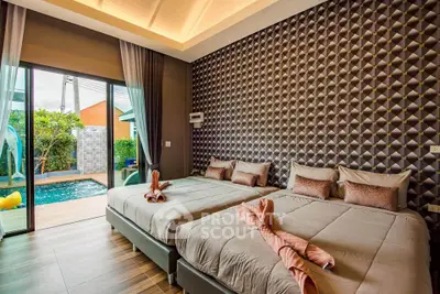 Luxurious bedroom with pool view and modern decor