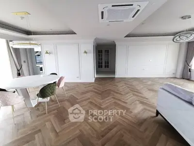 Spacious modern living room with elegant herringbone flooring and stylish furniture