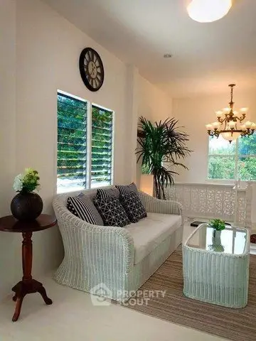 Charming living room with elegant wicker furniture and stylish decor, perfect for cozy relaxation.