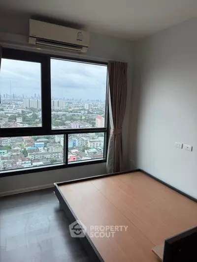 Modern bedroom with stunning city view and air conditioning in high-rise apartment.