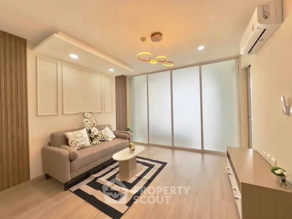 Modern living room with stylish decor and cozy ambiance, featuring a comfortable sofa and elegant lighting.