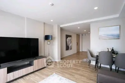 Modern living room with sleek TV unit and elegant dining area, perfect for contemporary living.