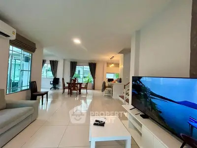 Spacious modern living room with open layout and large windows for natural light.
