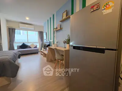 Modern studio apartment with stylish decor and spacious layout, featuring a cozy living area and sleek kitchen appliances.