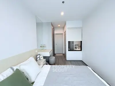 Modern minimalist bedroom with sleek design and neutral tones, featuring a cozy bed and stylish decor.