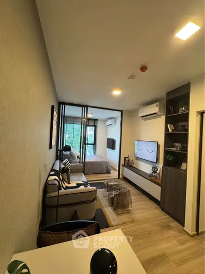 Modern apartment interior with stylish living room and bedroom, featuring sleek furniture and natural light.