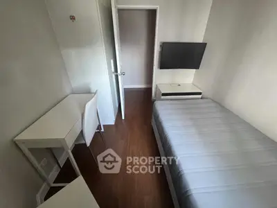 Cozy minimalist bedroom with modern furnishings and wall-mounted TV