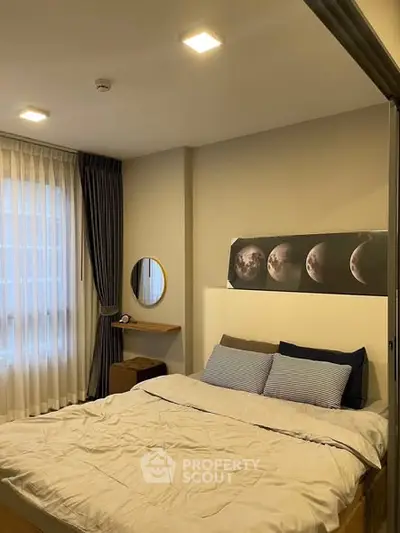 Cozy bedroom with modern decor and ample natural light