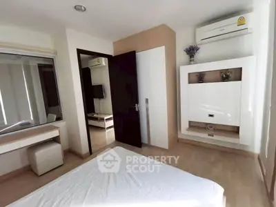 Modern bedroom with sleek furniture and air conditioning in a stylish apartment.