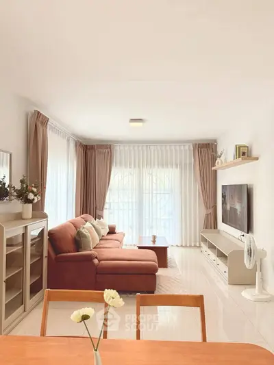 Spacious living room with modern decor and large windows for natural light.