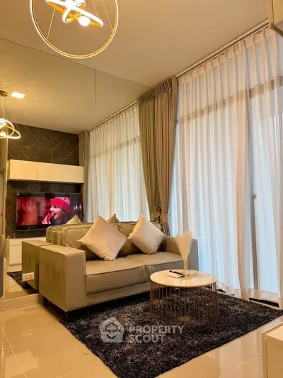Luxurious living room with modern decor, plush sofa, and elegant lighting in a stylish apartment.
