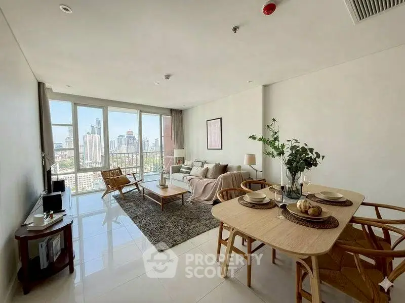 Spacious modern living room with city view, elegant furniture, and natural light.