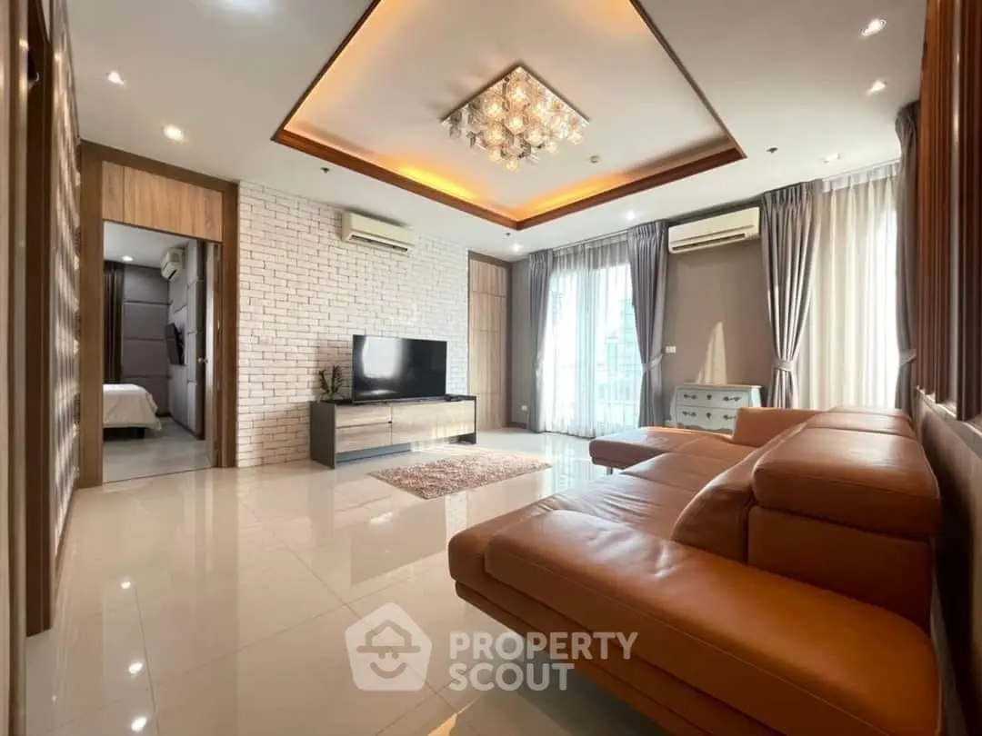 Luxurious living room with modern decor, leather sofa, and elegant lighting in a stylish apartment.