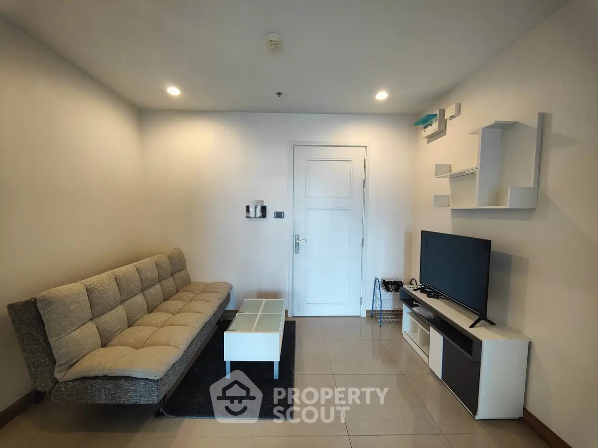 Modern living room with stylish sofa and TV unit, perfect for relaxation and entertainment.