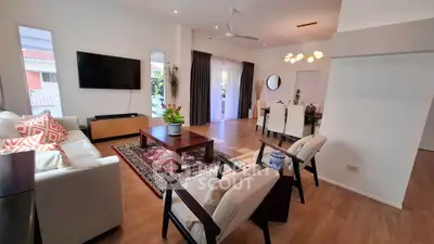 Spacious living room with modern decor and natural light, perfect for family gatherings.