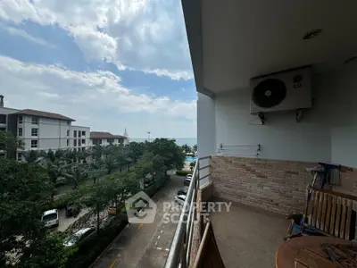 Stunning balcony view overlooking lush greenery and distant ocean horizon