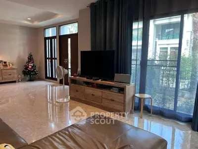 Spacious living room with modern decor and large windows