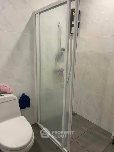 Modern bathroom with glass shower enclosure and sleek tile design