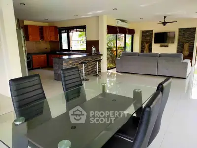 Spacious open-plan living and dining area with modern kitchen and stylish decor.
