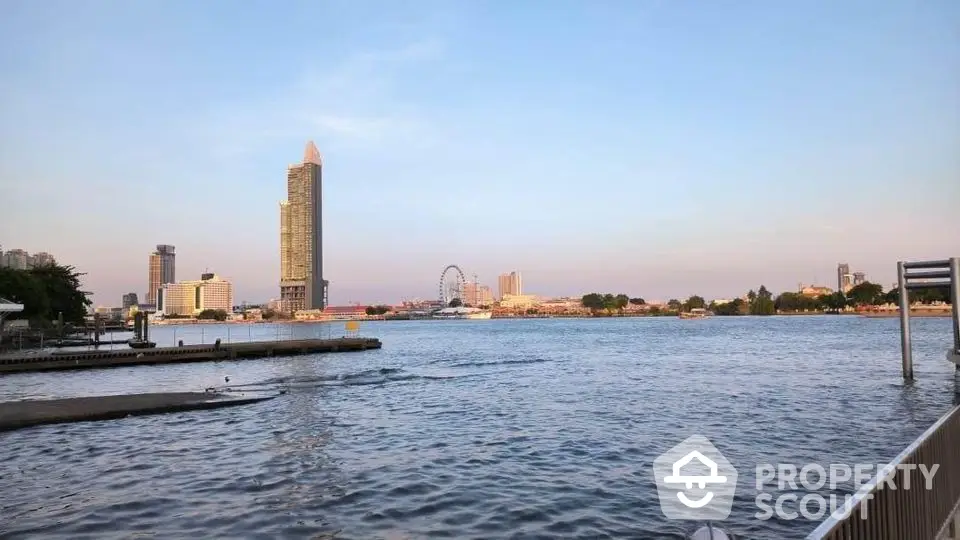 Stunning waterfront view with city skyline and iconic ferris wheel at sunset.